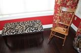 Upholstered zebra bench and antique rocker