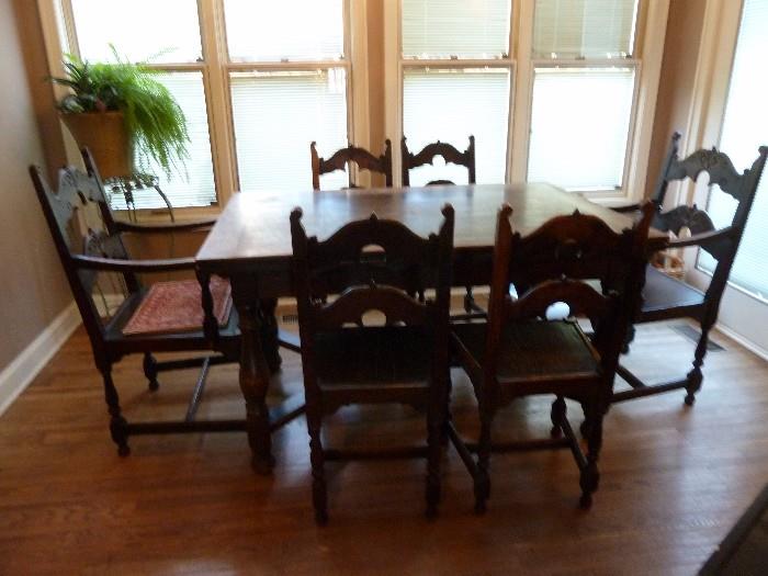 Antique drop leaf table with 4 chairs/2 captain chairs. This left Germany during the war. Matches sideboard/armoire/buffet.
