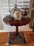 Cute, little round mahogany table, silver plated serving pieces, Japanese teapot, Goebel bird, silver overlay bowl, all sitting on it's own mini-Persian ruglet.