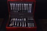 109-piece set of Gorham Chantilly Monogram, Service for 20 + Serving Pieces.                                                                                        This is a very sizable starter set, with five serving pieces, ready to grace your table, or to serve as a wonderful wedding gift. The forks and spoons all stack well and are not brand new, which is a good thing, so they do have negligible usage marks.

The set includes a mahogany chest, lined with Pacific cloth to prevent tarnishing, plus the following: 

20 PLACE SIZE KNIVES (MODERN BLADE) 9 1/8"
20 DINNER SIZE FORKS, 7 1/2"  (WEIGHS 2 lbs., 4 5/8 oz.)
20 SALAD FORKS, 6 1/2" (WEIGHS 1 lb., 10 3/8 oz.)
32 TEASPOONS, 5 3/4" (WEIGHS 2 lbs., 2 3/4 oz.)
12 HOLLOW HANDLE BUTTER SPREADERS, 6 1/4"
3 SERVING SPOONS, 8 3/8" (WEIGHS 7 5/8 oz.)
1 HOLLOW HANDLE MASTER BUTTER, 6 3/4"
1 PICKLE FORK, 2-TINE, 5 3/4" (Weighs 1/2 oz.)
Hallmarked as follows:
20 Luncheon Knives - 12 blades inscribed GORHAM / Sterling Handle / Stainless Blade; 8