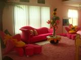 Hollywood Regency modern: Ultrasuede hot pink couch. Bretz Bros. hot pink clover ottoman table. Hot pink Ultrasuede artist custom-made orchid chair.