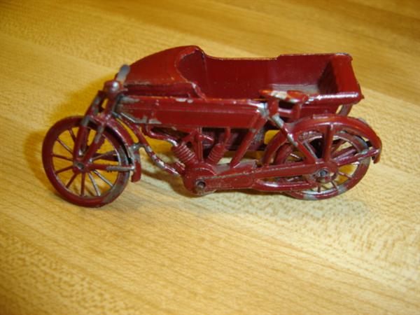 Marked "France", motorcycle with side car in original red paint; about 2"-3" long.
