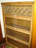 Several stacked barrister book cases, some old, some new.