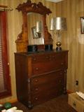 A Victorian walnut chest of drawers with a Victorian mirror balancing above.  The mirror is sold separately as it is not part of this chest.
