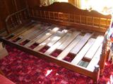 Jenny Lind style early trundle bed.  The story on this family piece is that is was dropped by the side of the road by a Mormon family that was on their way to Nauvoo, Illinois.  This is NOT a full-sized bed made into a bench.  It is an authentic trundle.