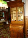 To the left:  Note this is not the same slag glass lamp pictured earlier.  We have two similar ones for sale.  To the right:  Victorian cylinder-roll desk with bookcase.