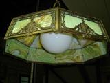 Many antique chandeliers and hangling lamps, this one with stained glass panels