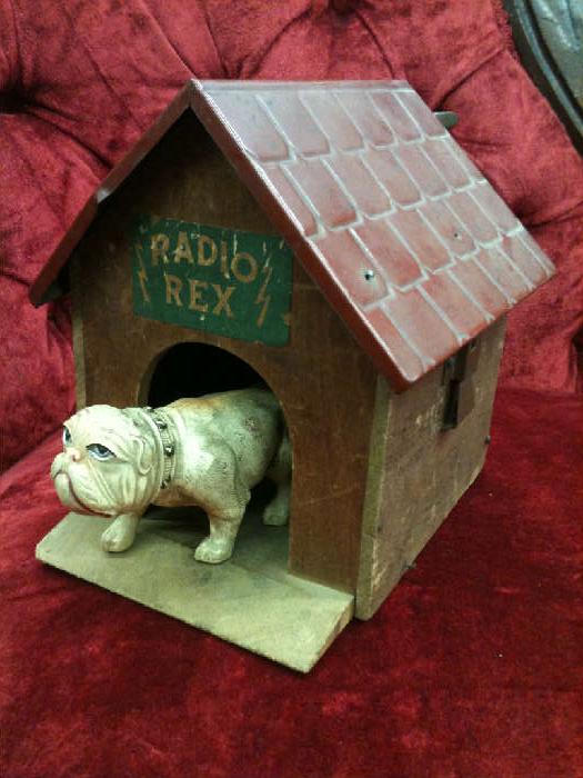 Radio Rex, 1922, first voice-activated toy!  We have two versions of this.  One has the older wooden roof with the brown celluloid dog and printed instructions on the bottom.  The version pictured here has an embossed tin roof with a white celluloid dog.