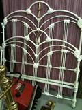 Circa 1900 full-sized (54" wide) iron bed with brass embellishments.  Includes box spring and rails.