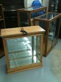Left:  Small 32" tall lighted display case in oak, opens at each side, with adjustable shelves.

Right:  Versatile 3-piece lighted display case in oak, opens front or back, with adjustable shelves and locks.  Each of the two cases is 36" tall.  Either one sits on the 6" tall base.  These pieces can be stacked to make one 6-1/2 foot tall case, or can be used separately.