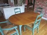 Cherry Table with antique shutter green legs, Two antique shutter green arm chairs with rush seats, Four antique shutter green side chairs with rush seats.