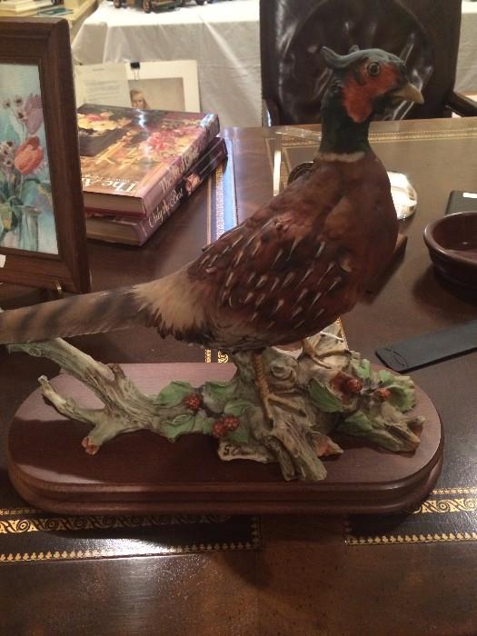 Porcelain bird on wooden stand