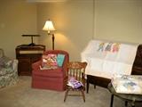 Lamp, TV cabinet, child's rocker, baby quilt
