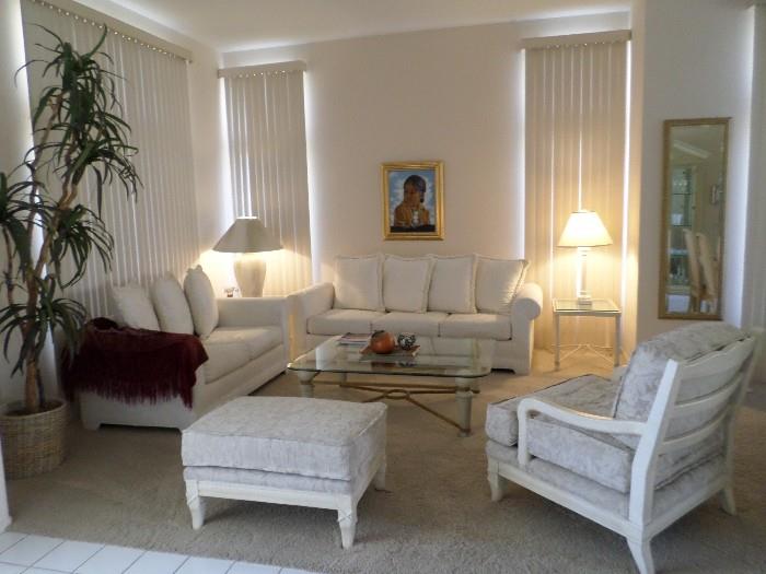 Living Room suite, couch, loveseat, large easy chair with ottoman, lamp tables, lamps,  large square glasss top coffee table, large beveled mirror in gold gilt frame.