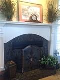 Greenery; Seth Thomas mantel clock; decorative fire screen; fireplace tools;