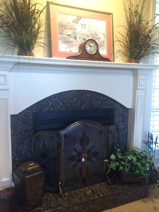 Greenery; Seth Thomas mantel clock;  decorative fire screen; fireplace tools; 