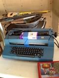vintage 80s IBM typewriter, saws, shovels, rakes