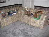 Standard size sofa and loveseat with many DVD's and some VHS tape sets.