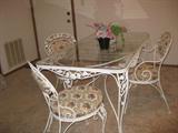 White Cast iron Table with Four Chairs. Removable cushions.