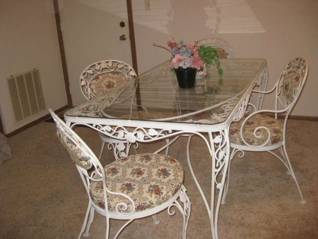 White Cast iron Table with Four Chairs.  Removable cushions.