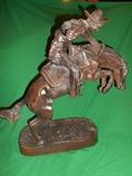 Parlor:  Large [reproduction] Frederic Remington "Bronco Buster."  Sculpture alone (without base measurement) is 18" tall X 20" wide.  Attached base is 18" long X 6-1/2" wide.
