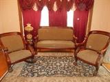 Parlor:  A three-piece late 1800's AMERICAN EMPIRE parlor set; the settee is 63" long.  All of the feet are large claws.  The rug [originally purchased at RUG WORLD in Brentwood]  has colors of blue and tan and measures 6' 1" x  9' 5."  The lamp to the left of the settee is a Victorian style lamp in creamy white with gold designs.  