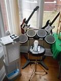 Sun Porch: Rock Band 2 drum kit is to the right of a Wii storage tower zig zag. The Guitar Heroes are priced separately.