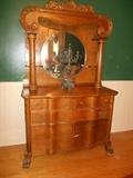 Dining Room: An antique oak sideboard measures 48" wide x 22" deep x 72" tall. A cast iron candelabra is also shown.