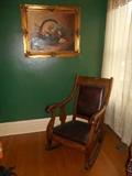 Butler's Standing Room-Off the Dining Room: An original still life painting by artist Jean Chase measures 30" x 36." It hovers above an antique AMERICAN EMPIRE rocker with leather upholstery.