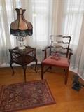 Butler's Standing Room-Off Dining Room: An antique side table displays a Victorian-style lamp. To the right is a ribbon back arm chair (more matching chairs are in the basement but need some work). To the right on the floor is a cast iron eagle. The small throw rug is also for sale.