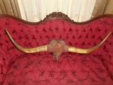 Parlor: We decided to display the VICTORIAN bull horns on the Victorian settee, of course! They measure 38" from tip-to-tip and are attached to a velvet heart design plaque.