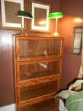 Second Floor - Bedroom #2: A reproduction lawyer's bookcase with four glass cases (actually all one unit). On top are two green glass shade banker's lamps.