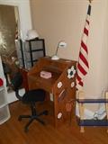 Second Floor - Bedroom #3: A view of the youth sports-theme desk; office chair; storage bins; and an American flag.
