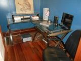 Second Floor Office Nook: A three-piece glass/metal desk set (two desks and a glass shelf); various office supplies.