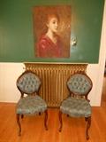 Dining Room: Two Victorian-style parlor chairs; a large canvas art portrait.