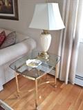 One of two glass top end tables