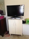 Small cabinet and flat-screen TV.
