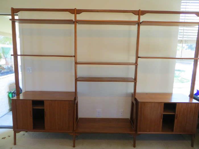 Vintage teak wall unit w/ adjustable shelves and invisible tambour doors.  Circa 1960's.  $1795