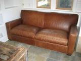 One of Pair Leather Loveseats
