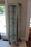 Brushed Nickel & Glass Rolling Curio Cabinet With 4 Adjustable Glass Shelves And A Mirrored Base - Maker Unknown -- This Is A Statement Piece
Condition: Excellent