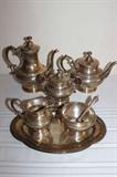 Sterling Silver Six Piece Tea & Coffee Set By The Meriden Brittania Co. 1895-1930--Including A Tea Pot, Coffee/Cocoa Pot, Creamer, Sugar Pot With Spoon, Sugar Cube Dish & A Small Tray--Marked Sterling & With It Body Number With A Open Wing Bird & A "M"--"LCD" Monogram--Book Value $1500--Total Weight: 2,195 Grams