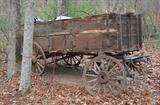 Vintage covered wagon waiting to be restored.