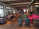 A Large Selection of McGuire Rattan Furniture: Chairs, Love Seats, and Tables.