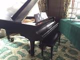 A Yamaha Piano (baby grand).