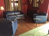 Vinyl loveseat and 2 club chairs, a selection of iron and glass tables.