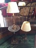 A pair of lamps and an Art Deco onyx table.