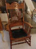 Antique rocking chair with carved back