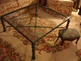Glass-top coffee table with cast metal base in verdigris finish, over beautiful all-wool sculptured rug
