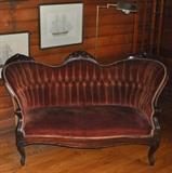 Outstanding Victorian settee with original wine-colored velvet upholstery.