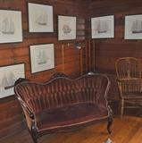Seven framed ship pictures,  Victorian settee with original wine-colored velvet upholstery, oak windsor chair.